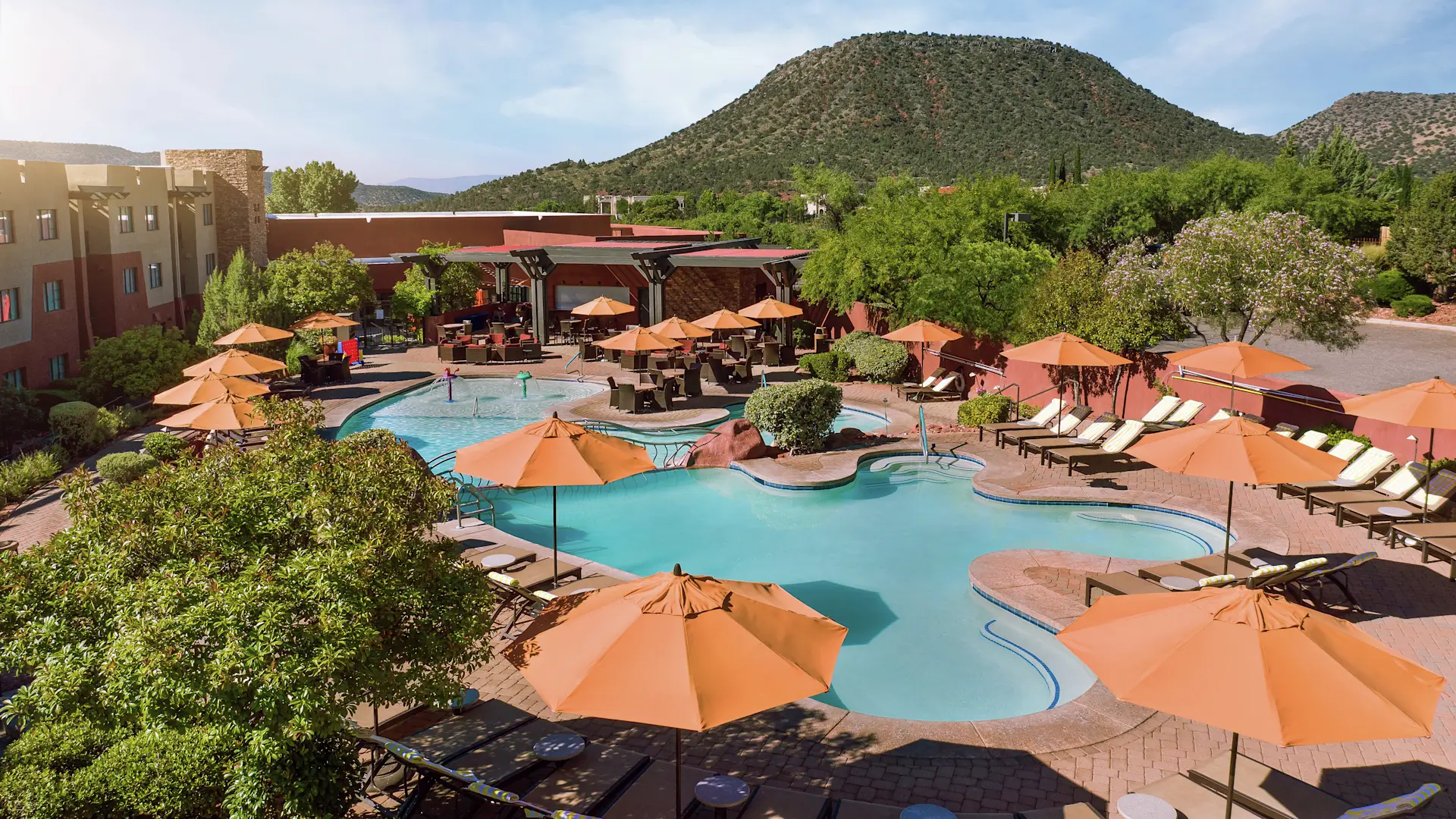 A pool with many umbrellas and chairs in it